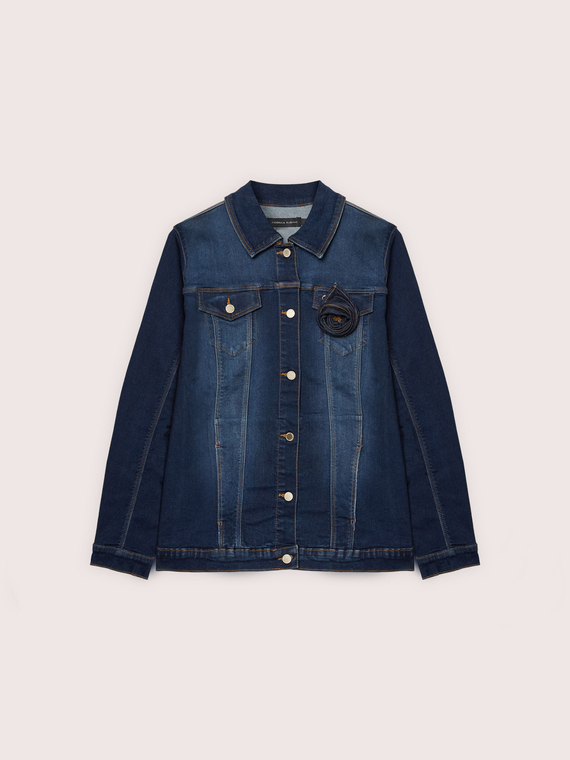 Denim jacket with floral brooch