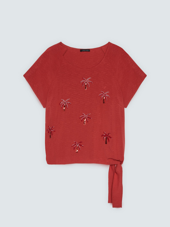 Top con applicazioni paillettes e nodo
